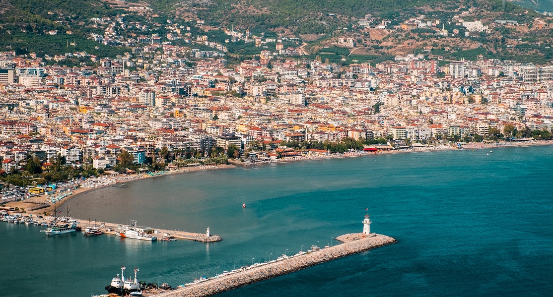 An aerial shot of the stunning Alanya resort town's residential areas and the sea on a sunny day